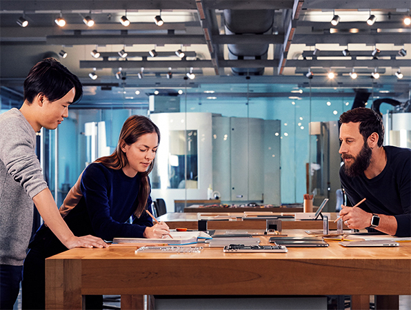 Apple designers collaborating on a project in their studio.