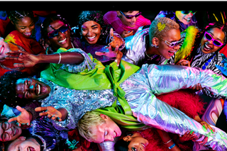 Colorful screen on a MacBook Pro of a person crowd-surfing at a party, showcasing the vibrant Liquid Retina XDR display