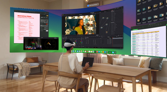 Apple Vision Pro를 착용한 채 책상에 앉아 MacBook Pro 13을 열어 놓은 사람의 모습과, 화면의 콘텐츠가 곡선형 울트라 와이드 디스플레이로 방 안에 투영된 모습