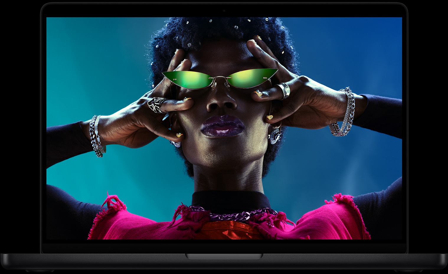 Colourful screen on a MacBook Pro of a person crowd-surfing at a party, showcasing the vibrant Liquid Retina XDR display