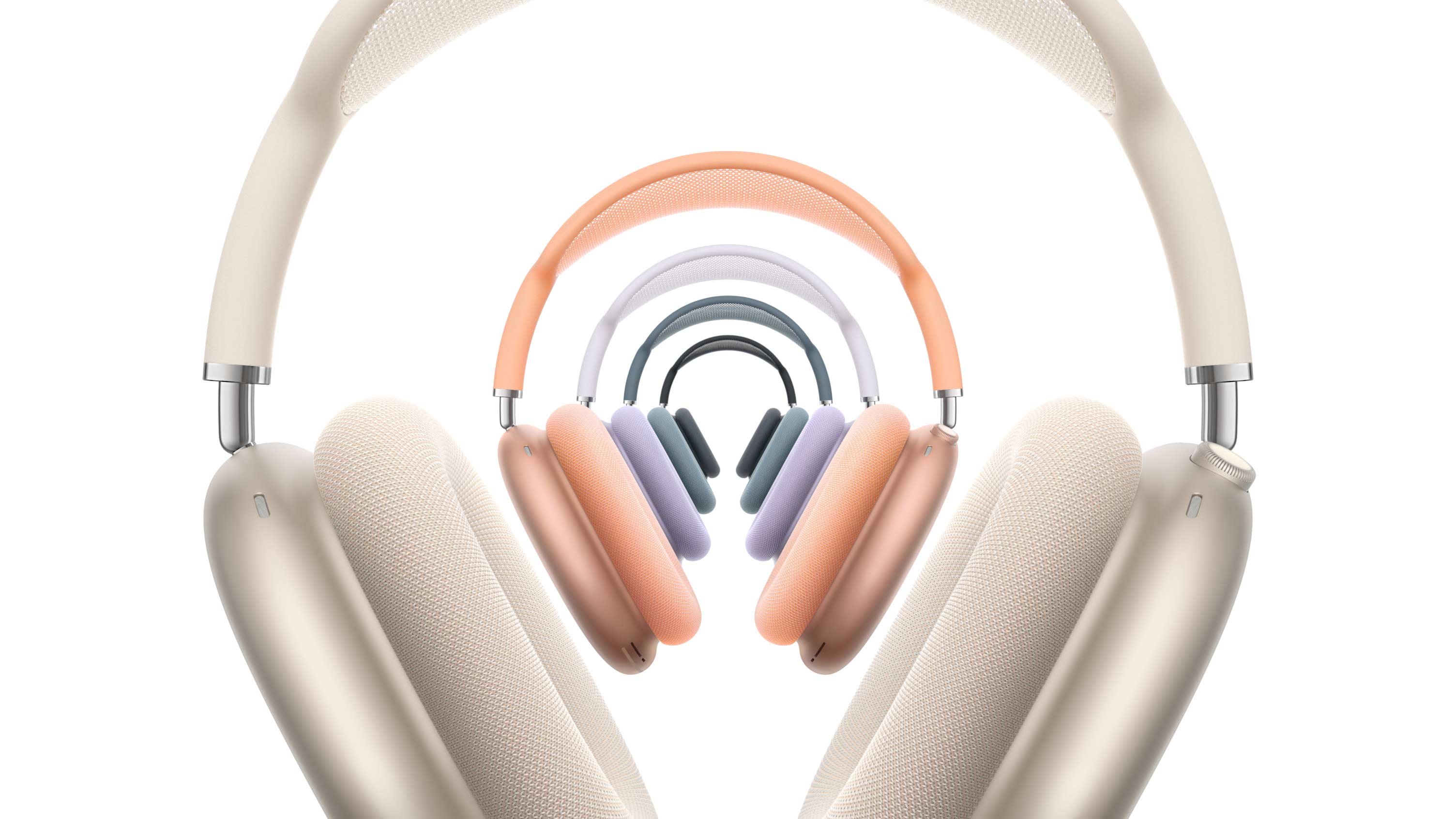 Five pairs of AirPods Max 2 headphones, front exterior, stacked, in Starlight, orange, purple, blue, and midnight colors