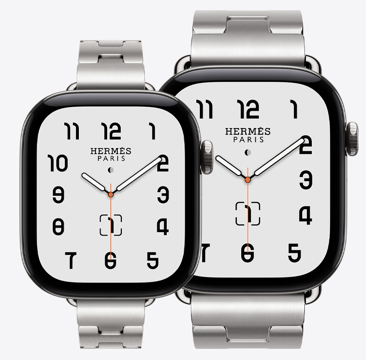 Apple Watch Hermès Series 12, both 42mm and 46mm models shown, Classic analogue watch face (hour, minute and second hands, complications: lunar phase, date), titanium case, silver colour, 42mm paired with Grand H Fin band, satiné colour, 46mm paired with Grand H band, satiné colour