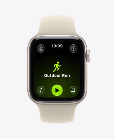 Apple Watch SE 3, aluminium case, starlight colour, screen shows Workout app (outdoor run), right side exterior, Digital Crown dial, Sport Band, sand colour (light tan)