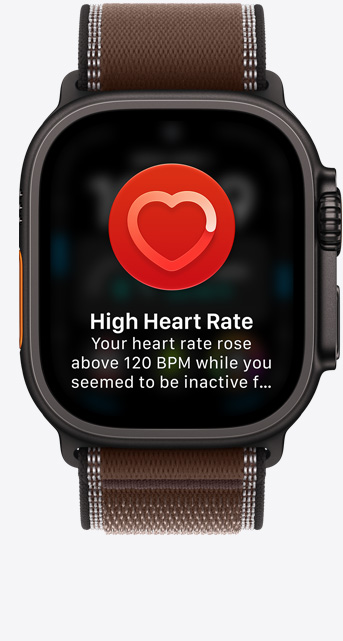 Apple Watch Ultra 4, screen shows Heart Rate app, current beats per minute, titanium case, black color, connected to Trail Loop band, dark umber color (brown)